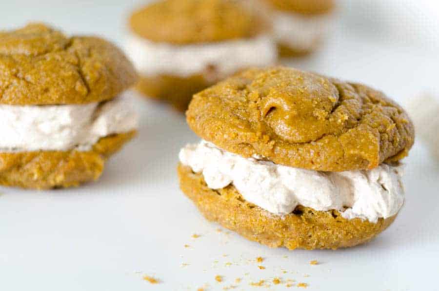 close up side view of pumpkin paleo whoopie pie with cinnamon cream filling