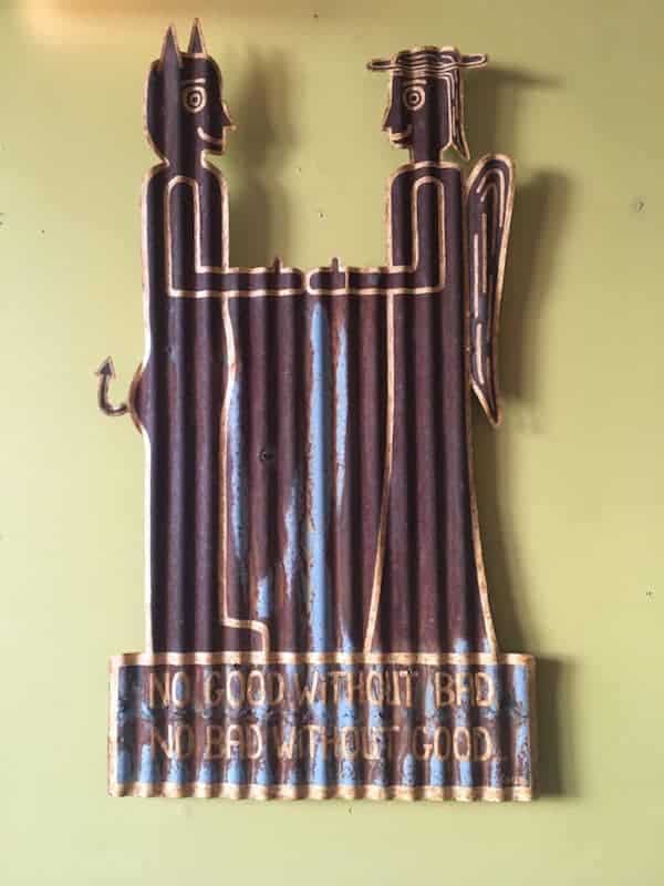 metal wall hanging on yellow wall