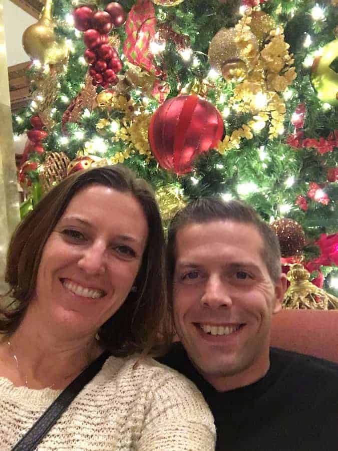 Man and woman in front of Christmas Tree