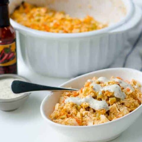 dish of buffalo chicken casserole with a spoon in it