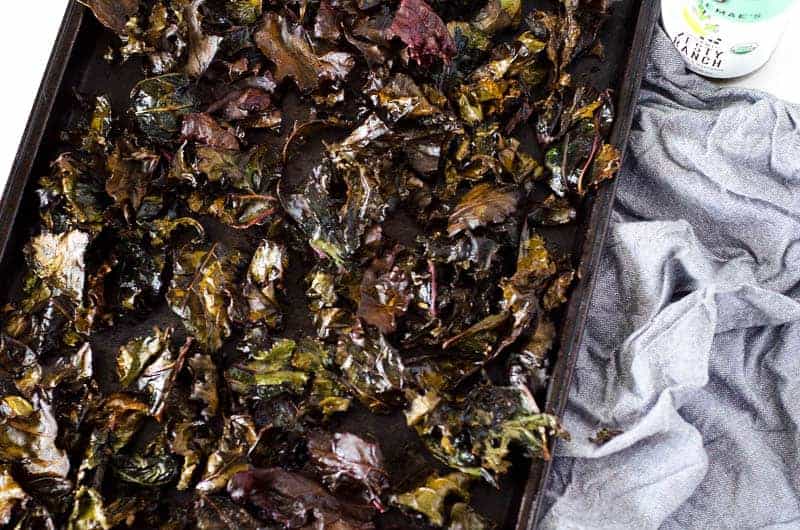 overhead view of kale chips on a baking sheet after cooking