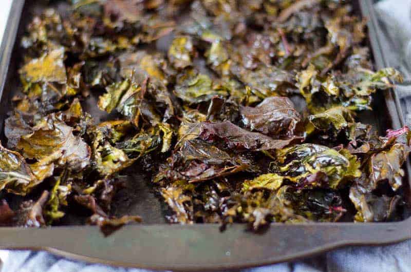 view of the end of a baking sheet covered in kale chips