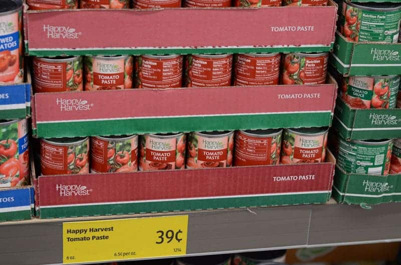 cans of tomato paste on shelf at Aldi