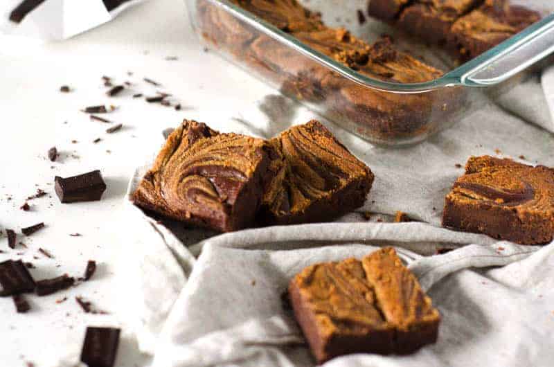 cut up gluten free dairy free brownies with pan in background