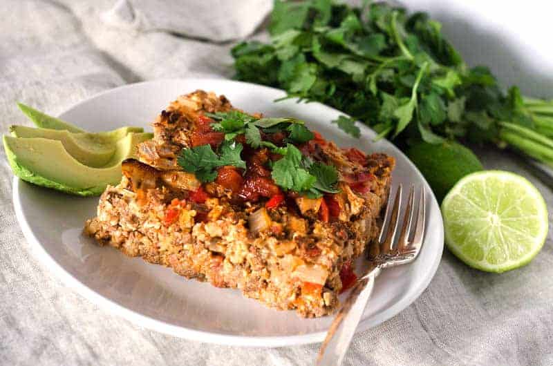 taco casserole served with cilantro and lime garnish