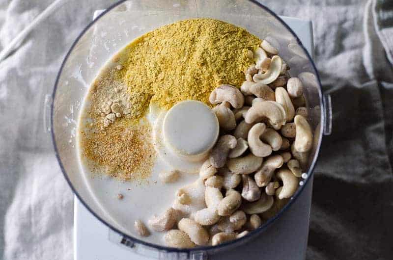 overhead view of food processor containing dairy free cheese sauce ingredients