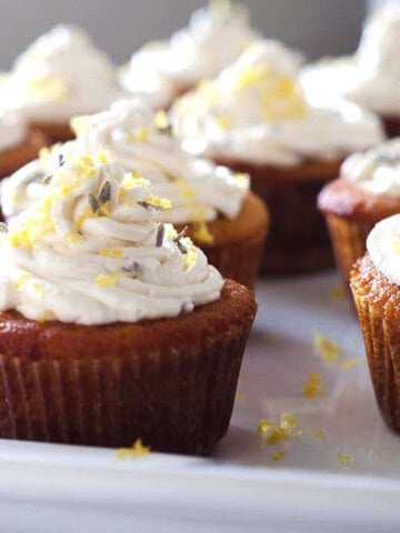 side view of grain free lemon lavender cupcakes arranged on a platter