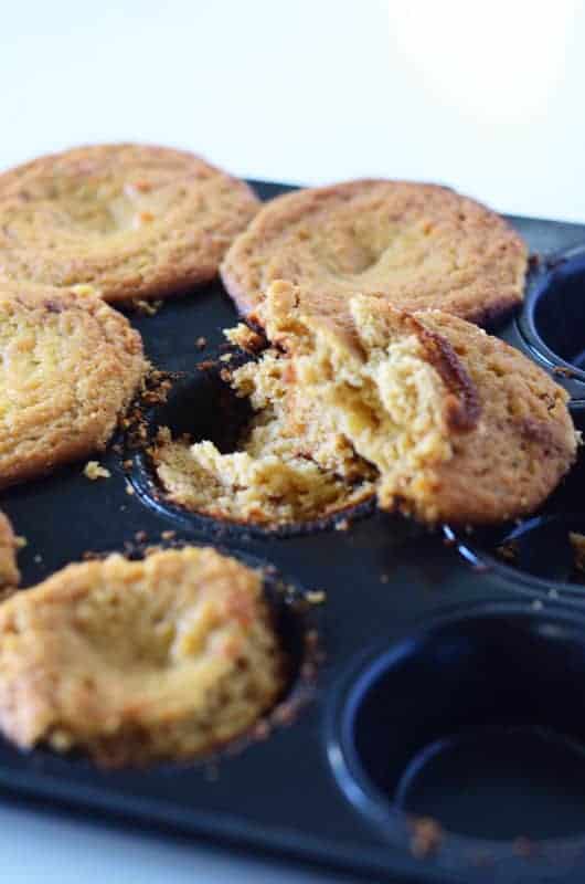 Side view of crumbling cupcakes in muffin tin