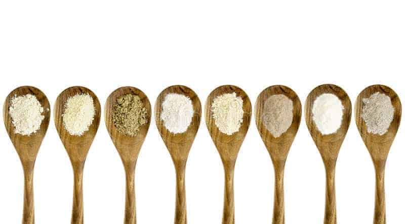 wooden spoons with variety of all purpose flour substitutes in them