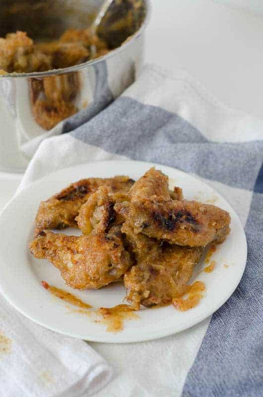 side view of a plate of sweet and spicy paleo chicken wings