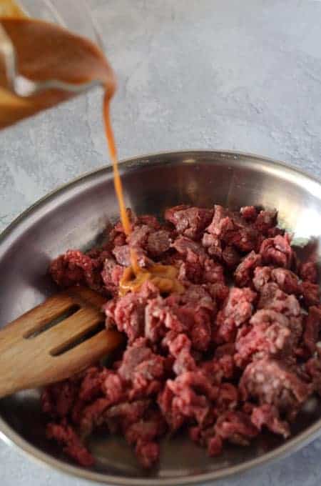 Ground beef cooking in pan with korean bulgogi sauce