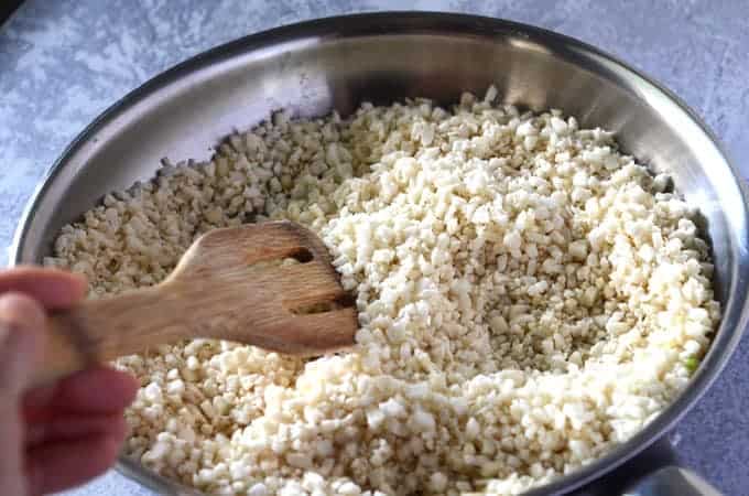 Cauliflower rice cooking in pan