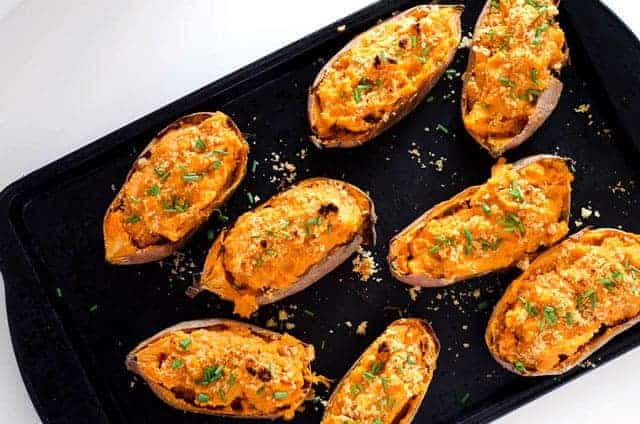 overhead view of baking sheet with twice baked sweet potatoes