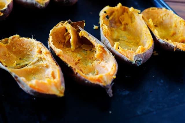 baking sheet with sweet potato skins and insides scooped out