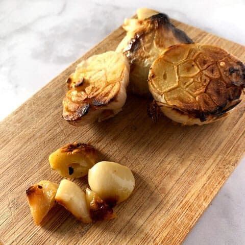 head of roasted garlic on cutting board