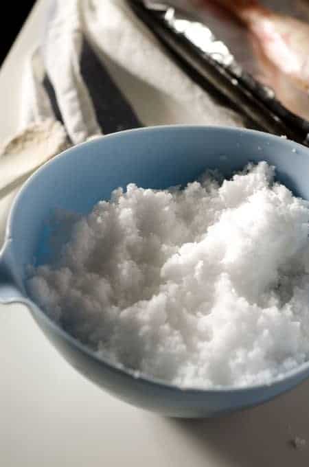 Blue bowl filled with water/salt mixture for a salt crust