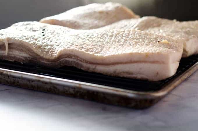 Close up of pork belly on a baking sheet