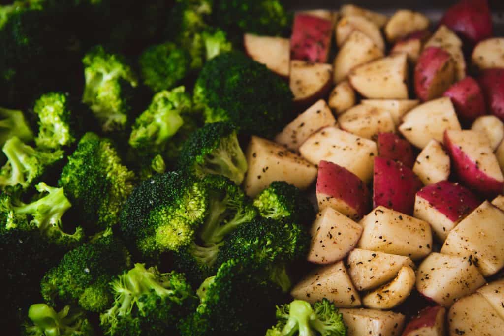 Close up image of broccoli and roasted potatoes