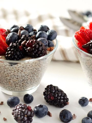clear cup of chia pudding topped with fresh berries
