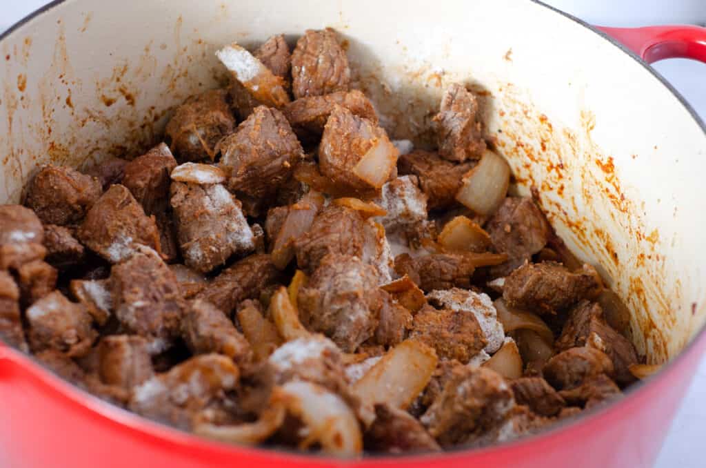 dutch oven with paleo beef stew meat in it