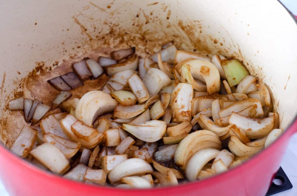 dutch oven with onions garlic and balsamic vinegar cooking in it