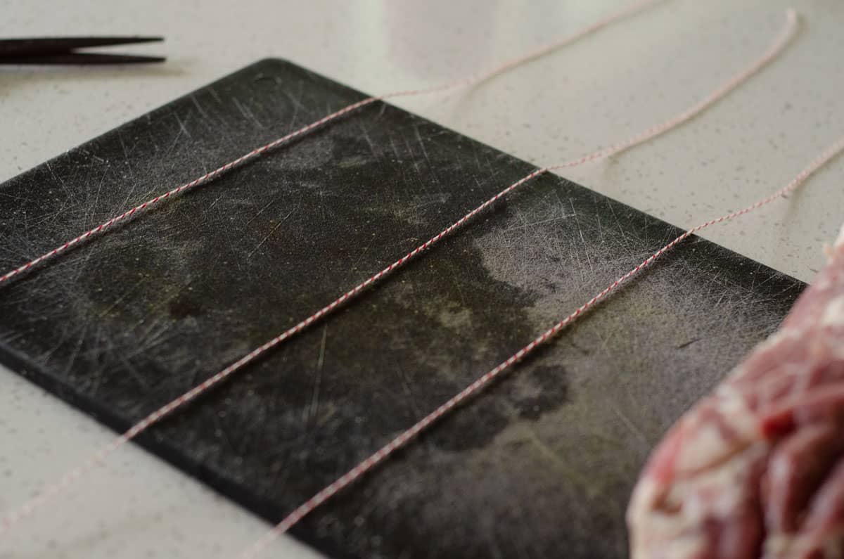 Cutting board with string laid out on it