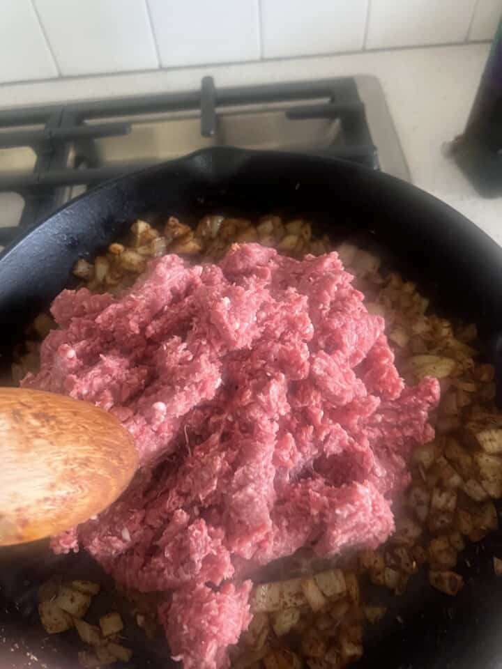 ground lamb added to cast iron skillet