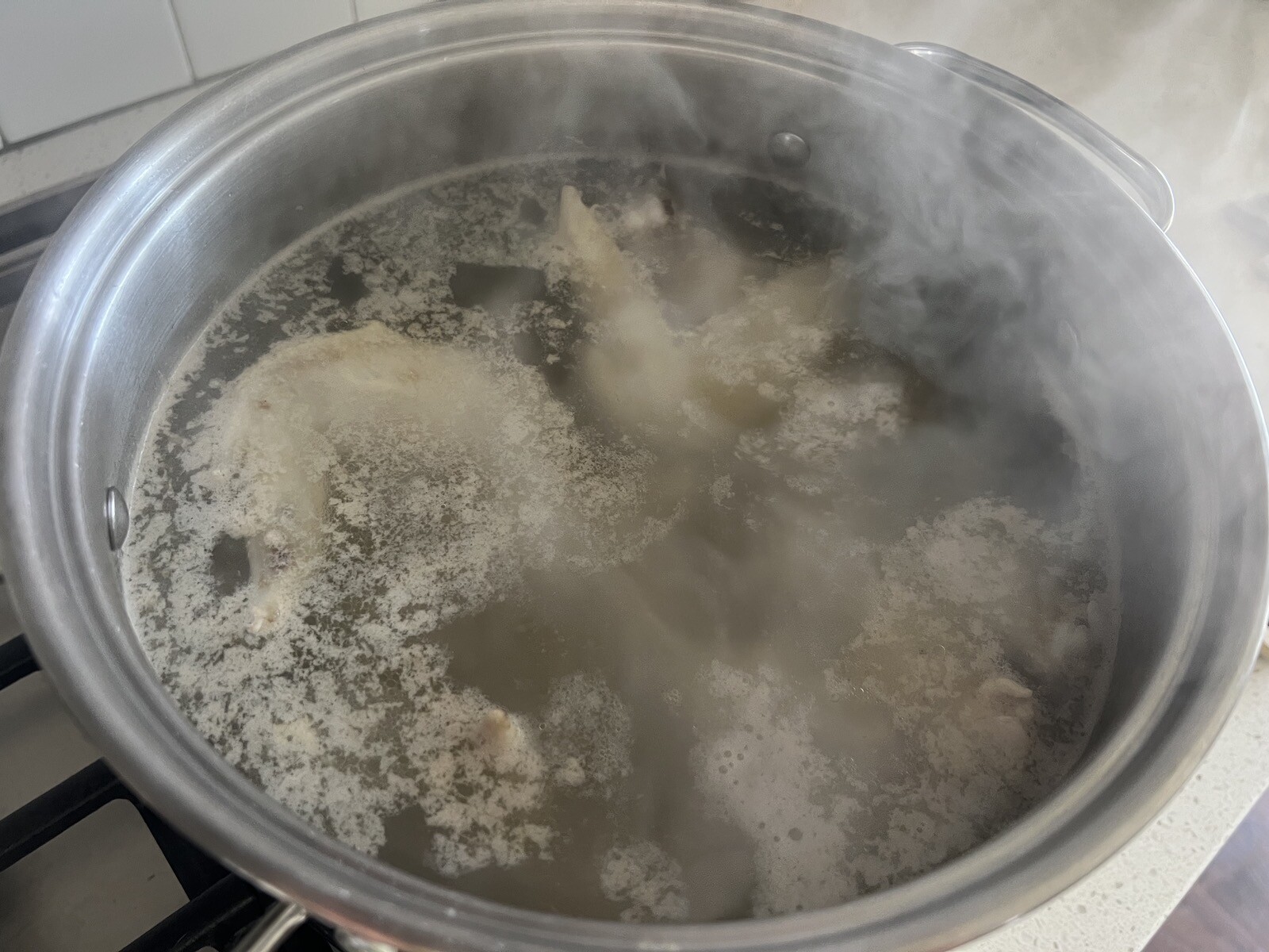 chicken wings boiling in stockpot