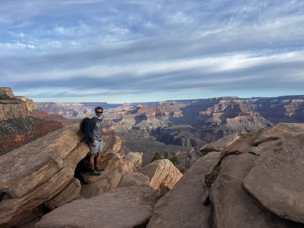 man standing at the overlook at ooh aah point grand canyon