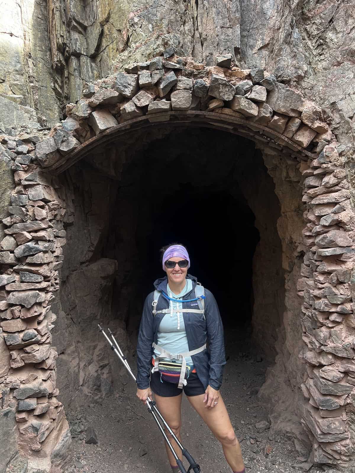 woman standing in front of tunnel south kaibab trail