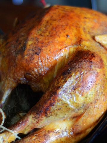 close up image of a smoked turkey with a browned skin