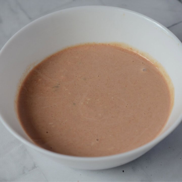 white bowl with burger sauce in it