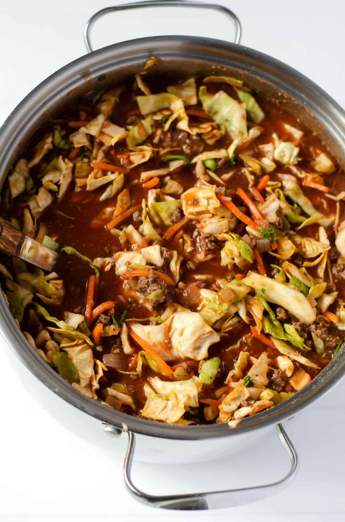 Overhead view of a full pot of ground venison soup